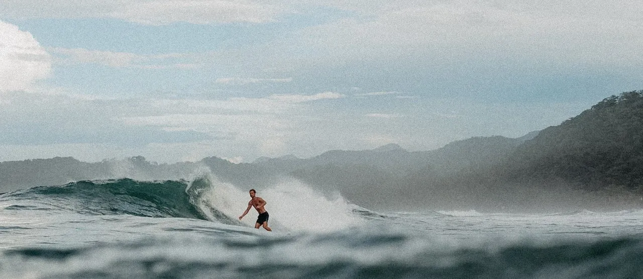 Surfer riding a wave in Cambutal